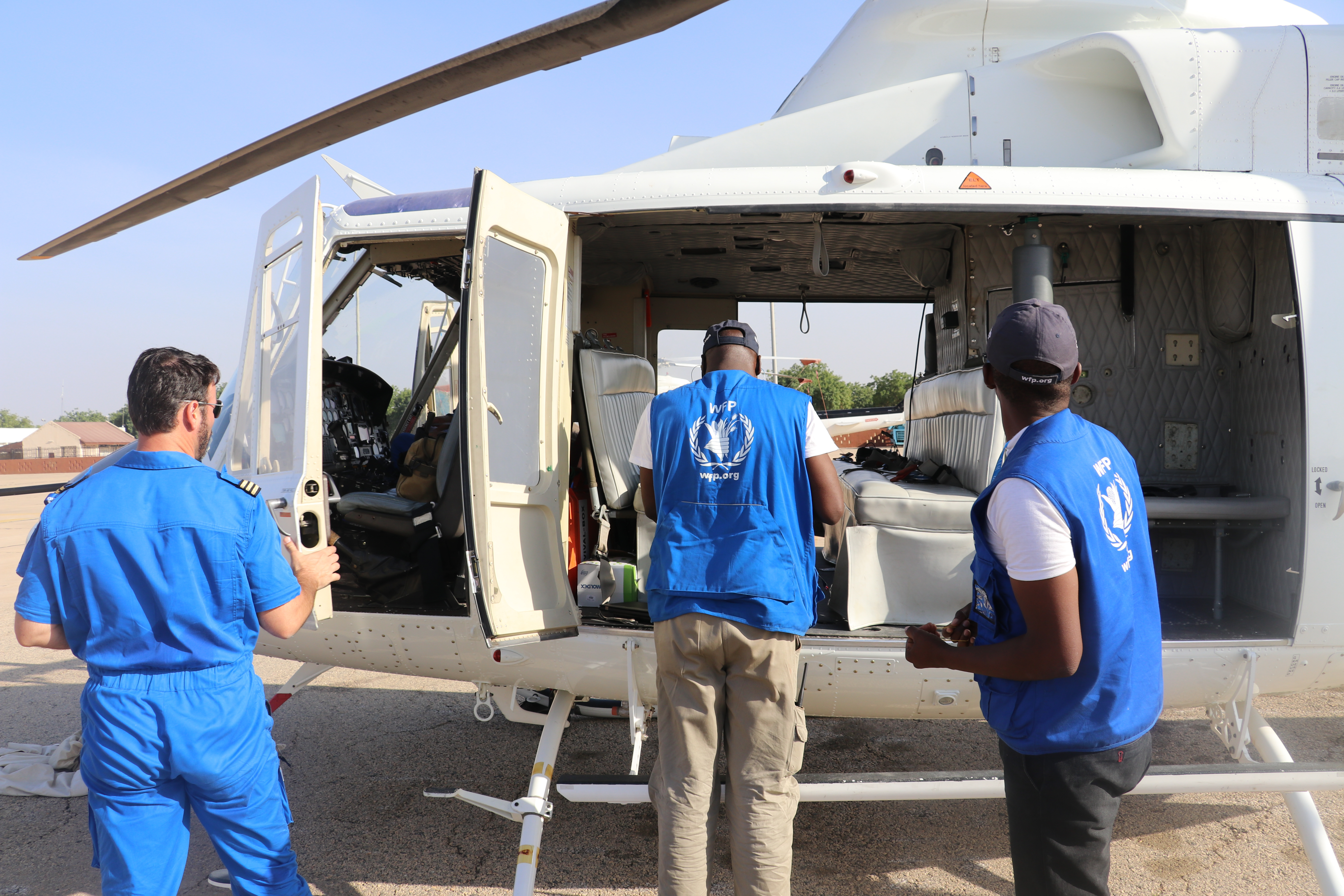 Nigeria, Monguno, 21 January 2017

Coupled with the existing challenges of extreme poverty, underdevelopment and climate change in the Lake Chad region, Boko Haram violence has led to one of the most acute and sorely neglected humanitarian crises in the world.

Some 7.1 million people need food assistance across four countried - Nigeria, Cameroon, Chad and Niger. Famine looms for over 120,000 people in the areas most affected by crisis in north-east Nigeria.

As malnutrition rises to alarming levels in all four countries, over half a million children are suffering from severe acute malnutrition.

In north-eastern Nigeria alone, some 1.9 million people have been forced to flee their homes due to conflict and insecurity. Almost 200,000 refugees from Nigeria are registered in neighbouring countries - finding shelter within host communities who were already among the poorest in the world.

In the photo: during a Rapid Response Mission (RRM) to Monguno, WFP distributed food to 78,000 people. Here, members of the WFP RRM team disembark the helicopter.

Photo: WFP/Amadou Baraze